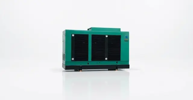 Industrial diesel genset in a green enclosure.